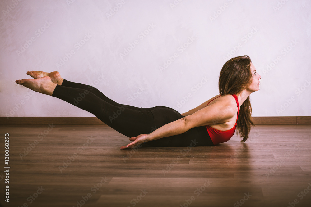 Naklejka premium Pretty woman practicing yoga at home