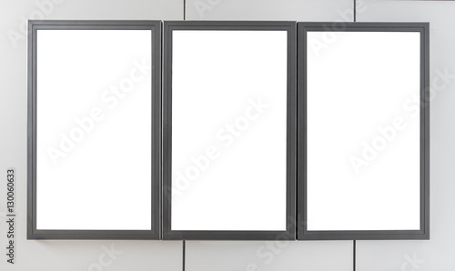 Three blank billboards display on modern wall for advertisement content