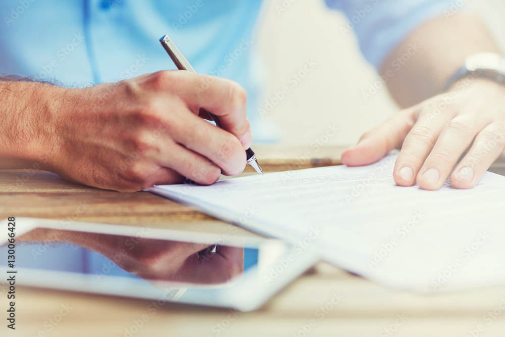 Close-up of men signing document, contract