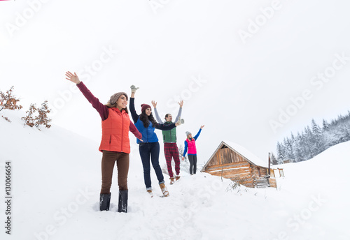 Friends On Mountain Top Winter Snow Forest, Young People Group Cheerful Raised Hands Wood Nature Landscape