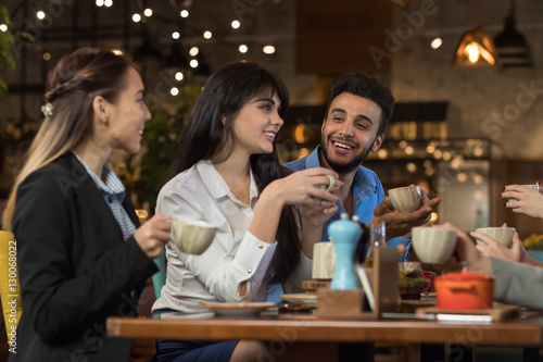 Young Business People Group Drink Coffee Sitting Cafe Table  Friends Hold Cup Smiling Mix Race Men Women Talking