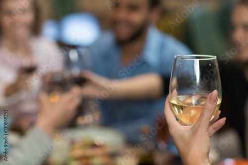 Young Business People Group Drink Wine Sitting Restaurant Table, Friends Hold Glasses Toasting Smiling Mix Race Men Women