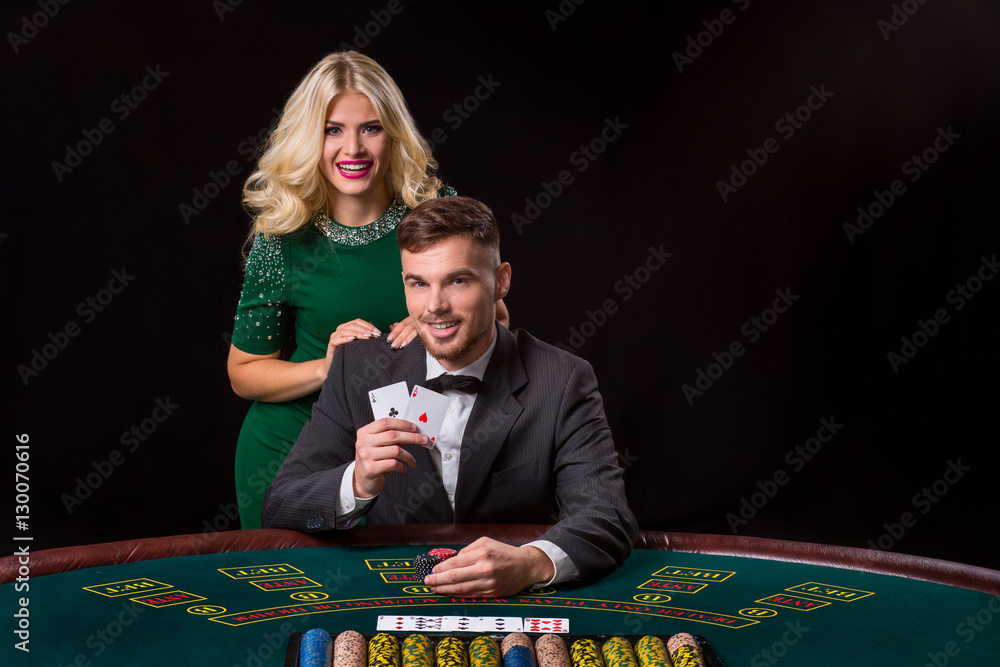 couple playing poker at the table. couple playing poker at the table.