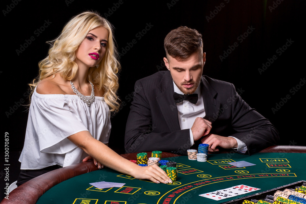 couple playing poker at the table. couple playing poker at the table.