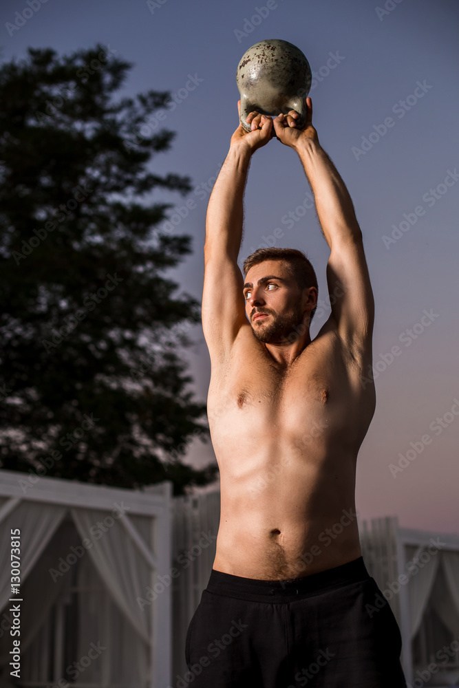 Muscular man working with weights at outdoor Muscular man working with weights at outdoor