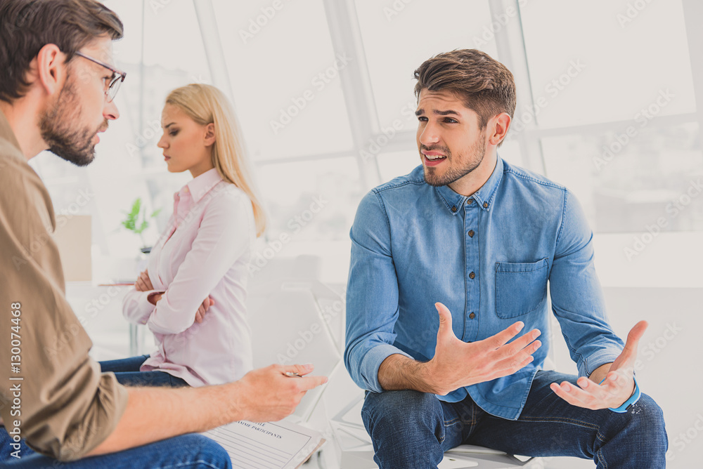 Fototapeta premium Unnerved man talking with psychologist