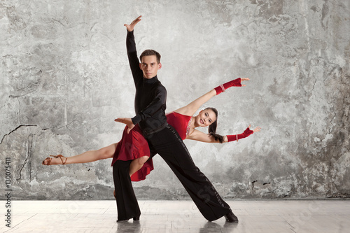 Beautiful couple in the active ballroom dance on wall © Andrey Burmakin