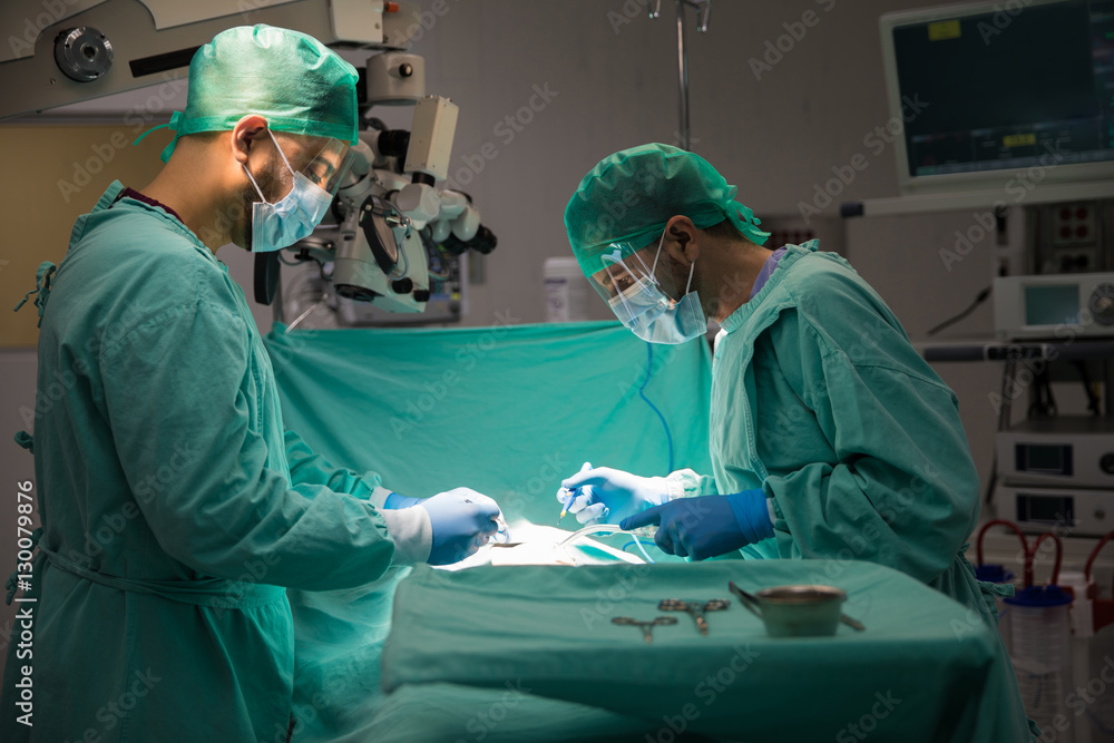 Two surgeons operating on a patient Two surgeons operating on a patient