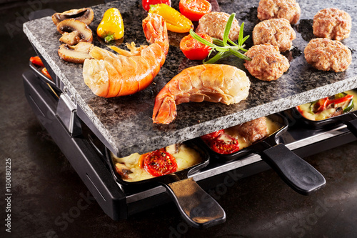 Canvas Print Tasty prawn tails cooking on a raclette grill