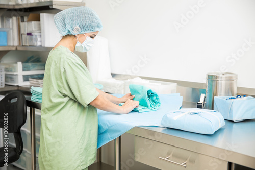 Woman packing sterile scrubs in hospital