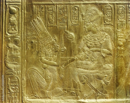 Detail of the exterior of the gilt shrine showing the king pouring perfumed liquid into the queen's hand, from the tomb of the pharaoh Tutankhamun, discovered in the Valley of the Kings, Thebes, Egypt