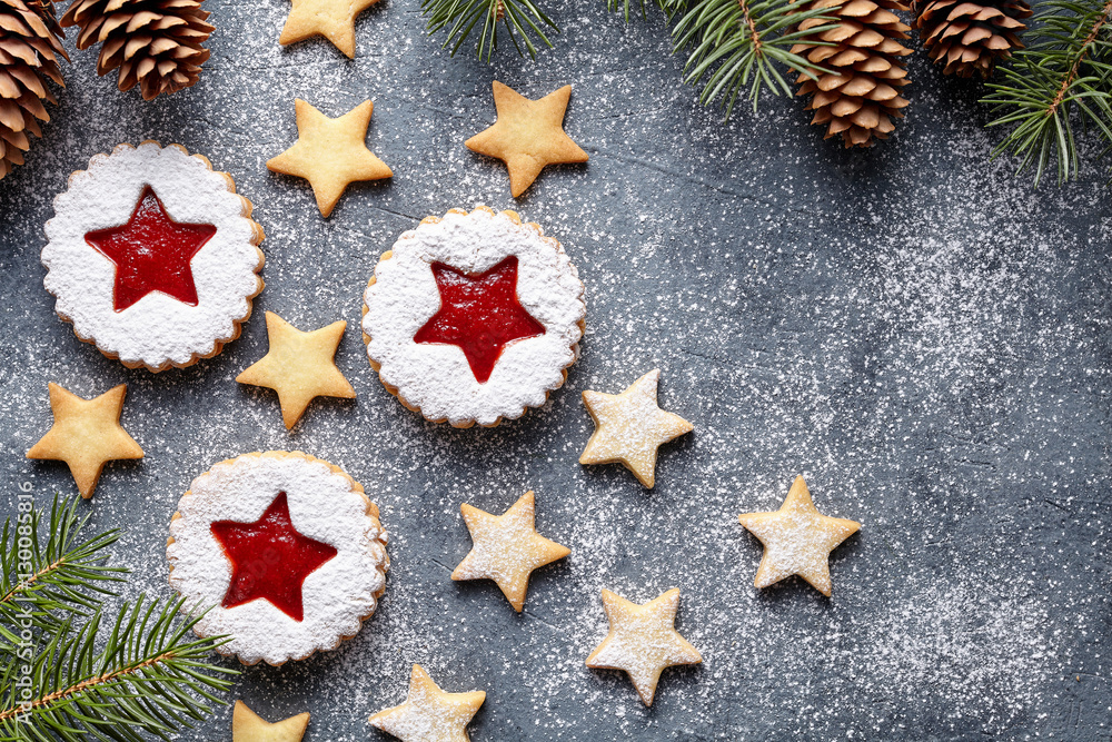 Christmas or New Year homemade ginger cookies star with strawberry jam. Traditional Austrian dessert - Linzer biscuits. Flat lay. Festive decoration. Top view. Copy space. Christmas or New Year homemade ginger cookies star with strawberry jam. Traditional Austrian dessert - Linzer biscuits. Flat lay. Festive decoration. Top view. Copy space.