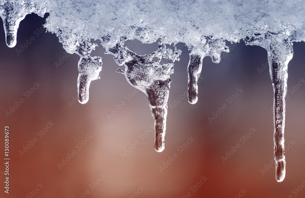 shiny clear ice icicles hang on a clear day shiny clear ice icicles hang on a clear day