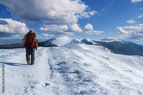 Backpacker  in winter mountains with beautiful landscape