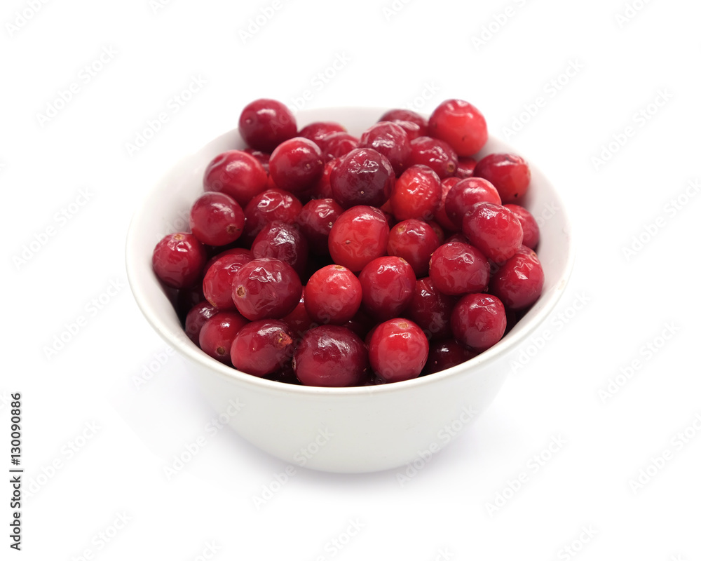 Cranberries in round white bowl isolated on white background indoor top view close up Cranberries in round white bowl isolated on white background indoor top view close up