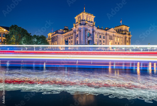 Berlin government district with Reichstag and light trails of a ship on Spree river in twilight, Berlin Mitte, Germany photo