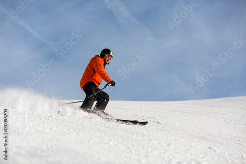 Male skier skiing on ski slope