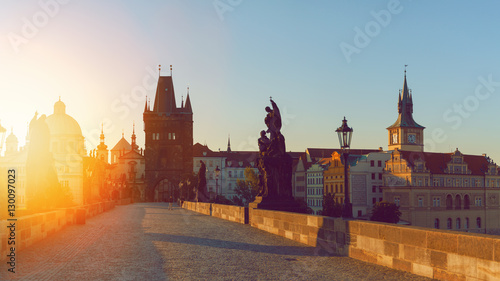 Prague, Czech Republic. Charles Bridge with its statuette at sunrise, Old Town Bridge Tower in the background.
