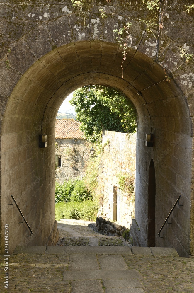 Fototapeta premium Stone arch in alley in Tui, Galicia, Spain