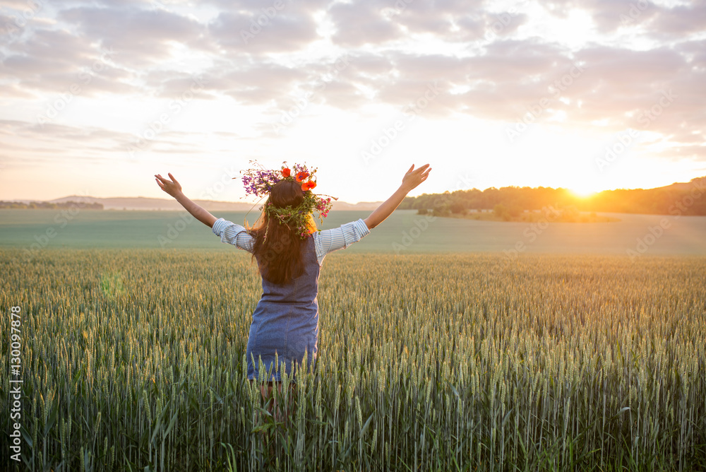 girl in a wreath greets the sun in the field girl in a wreath greets the sun in the field