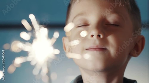 Happy adorable kid celebrating his birthday and make a wish