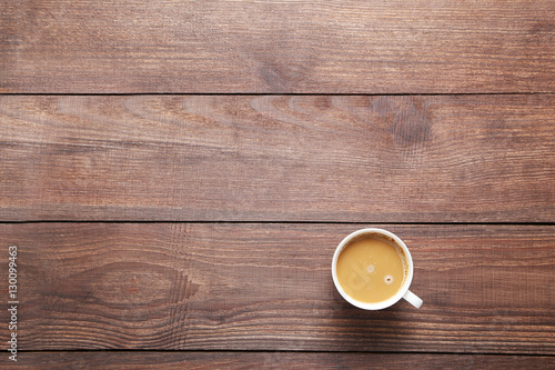 Cup of coffee on a brown wooden table