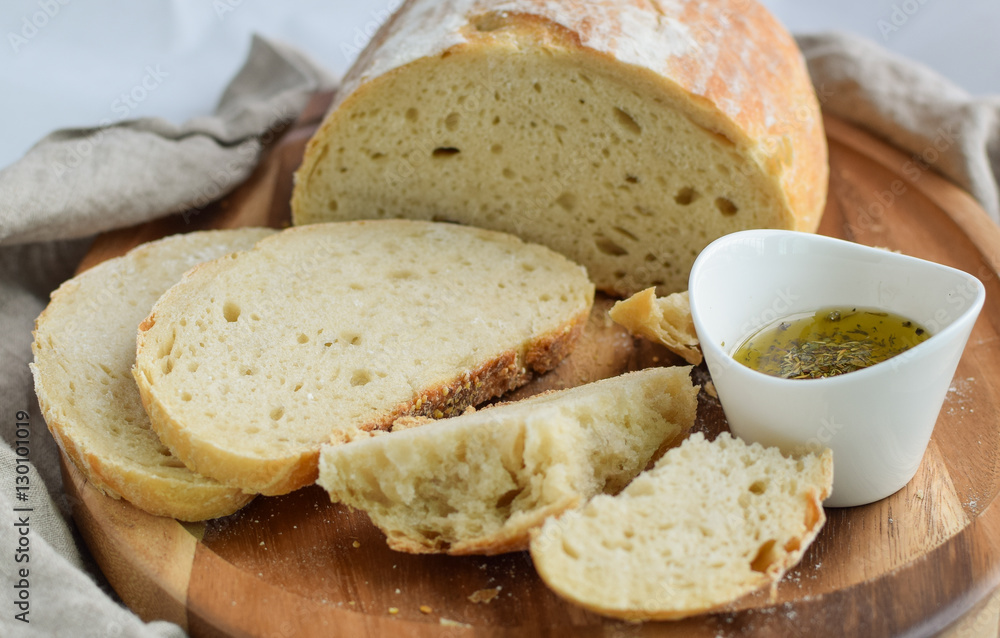 Fresh homemade sourdough bread torn in pieces with oil and herbs Fresh homemade sourdough bread torn in pieces with oil and herbs