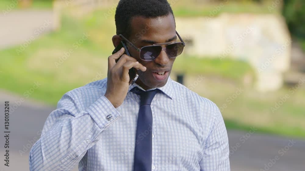 African american businessman quarreling using mobile phone: holding documents African american businessman quarreling using mobile phone: holding documents
