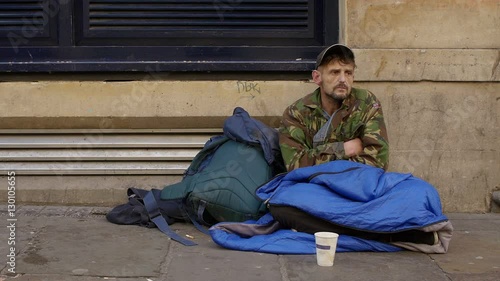 homeless begging in the street: young jobless man 