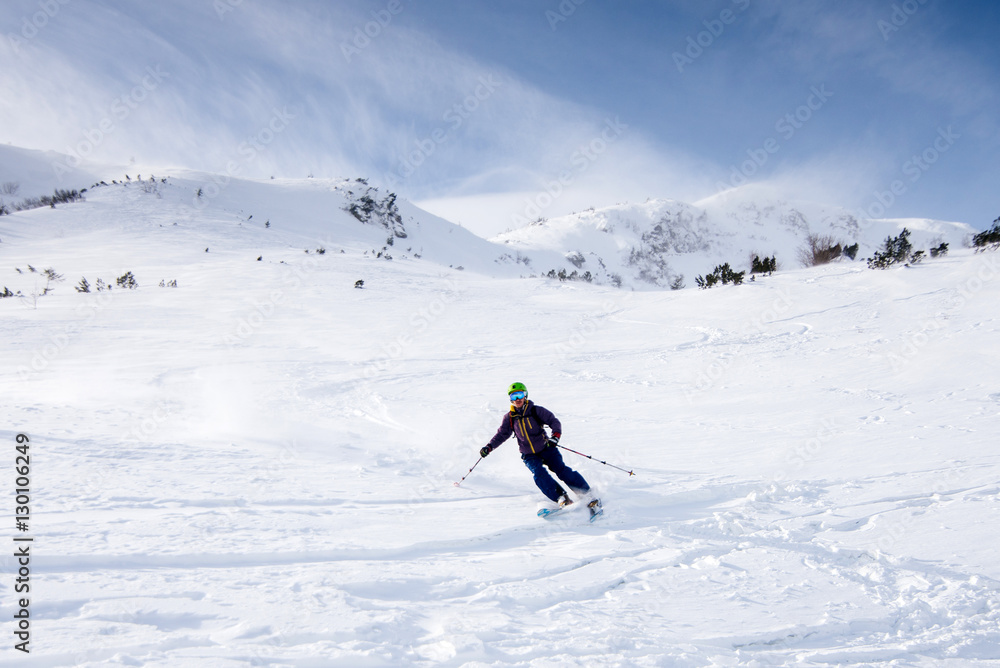 Skier riding on fresh snow in the Carpathian mountains, Ukraine
