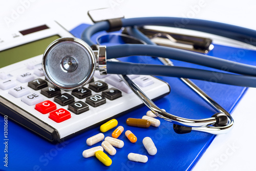 Stethoscope, pills and bottles on color background. medicine con