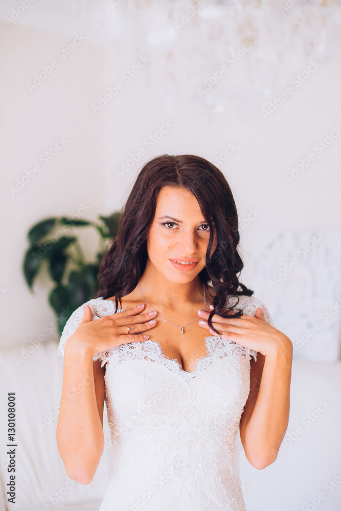 Bride getting ready. Bride dressing gown. bride is getting ready in the morning. Brides maid helps bride dress in wedding dress for wedding day Bride getting ready. Bride dressing gown. bride is getting ready in the morning. Brides maid helps bride dress in wedding dress for wedding day