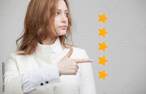 Five star rating or ranking, benchmarking concept. Woman assesses service, hotel, restaurant