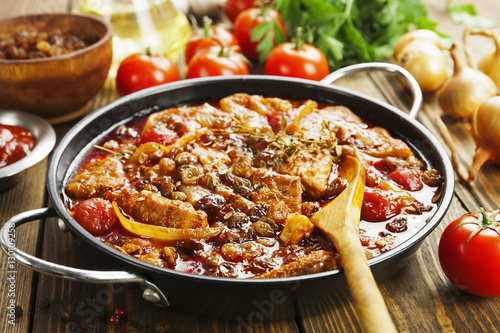 Pork stew with tomatoes and raisins