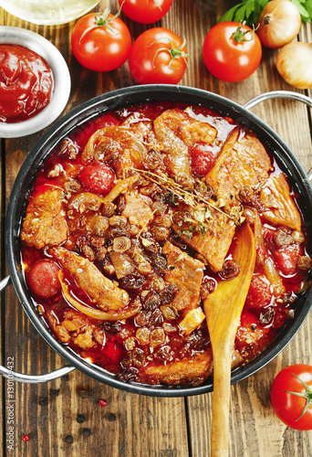 Pork stew with tomatoes and raisins