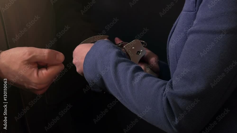 Female detective arresting and handcuffing criminal, police procedure