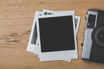 Blank vintage instant photograph with a retro camera