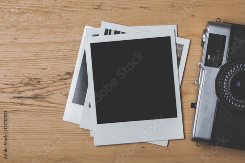 Blank vintage instant photograph with a retro camera