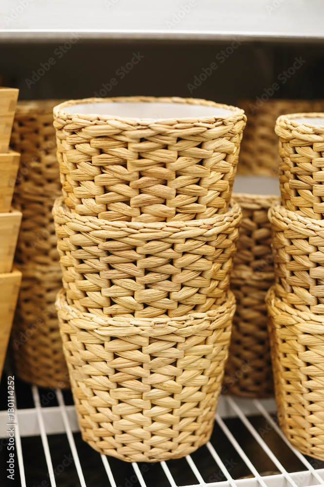 woven straw baskets on a shelf in store