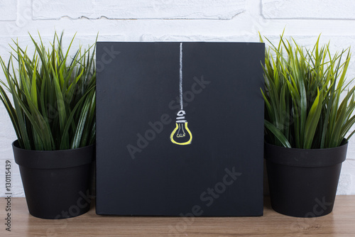 Idea Light Bulb on Blackboard photo