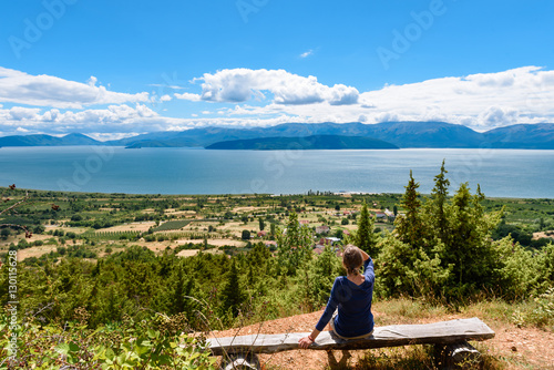 Girl in blue shirt looking at Lake Prespa from Pelister National Park in Macedonia.