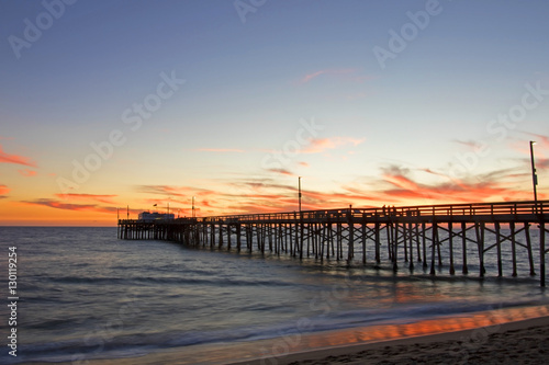 Beach pier at sunset in California