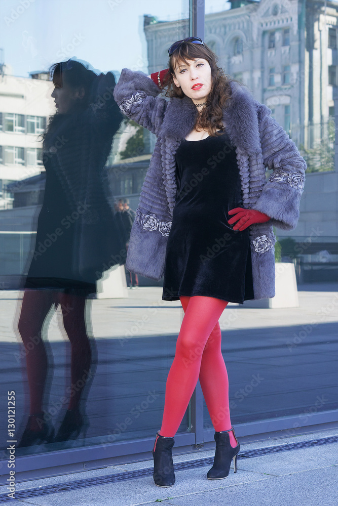 Sexy woman in a black dress, red tights 