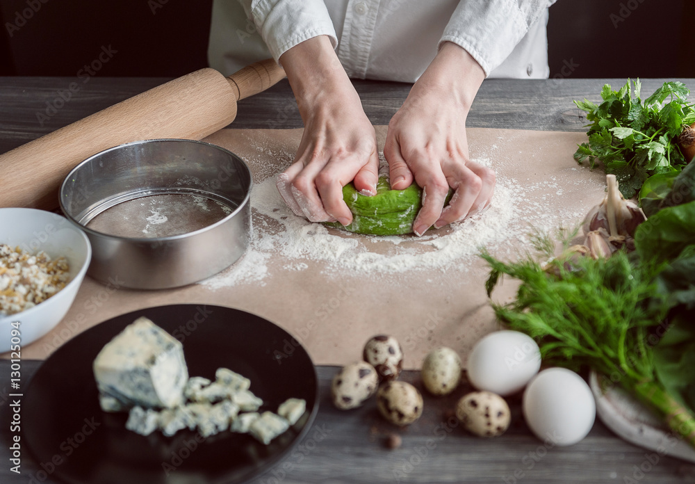 woman kneads dough for ravioli