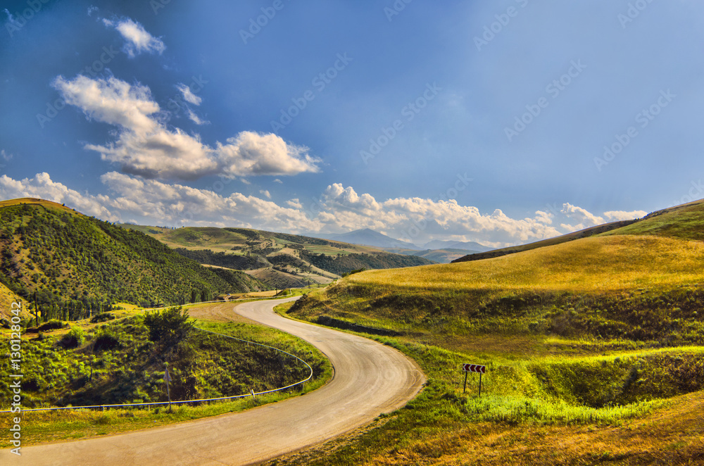 Cycling mountain road. Misty mountain road in high mountains.. Cloudy sky with mountain road 