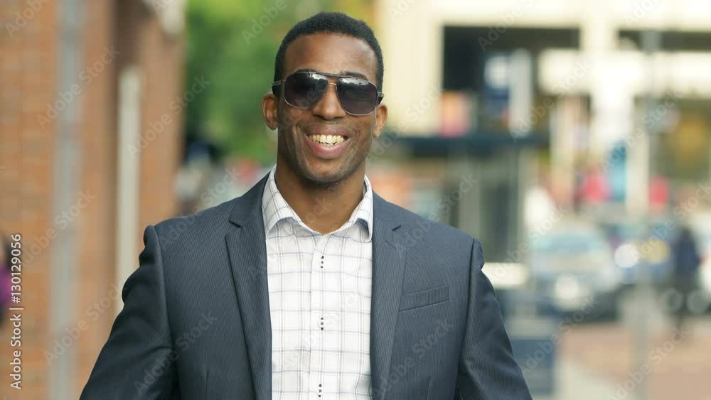portrait of a smiling handsome businessman in the city portrait of a smiling handsome businessman in the city