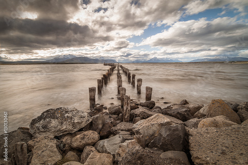 boat pier with old logs and stilts for landscape travel background