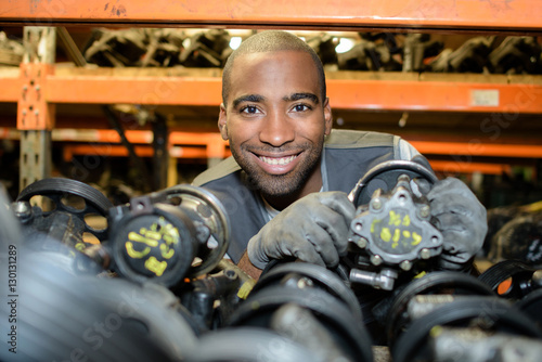 Man working with used car parts