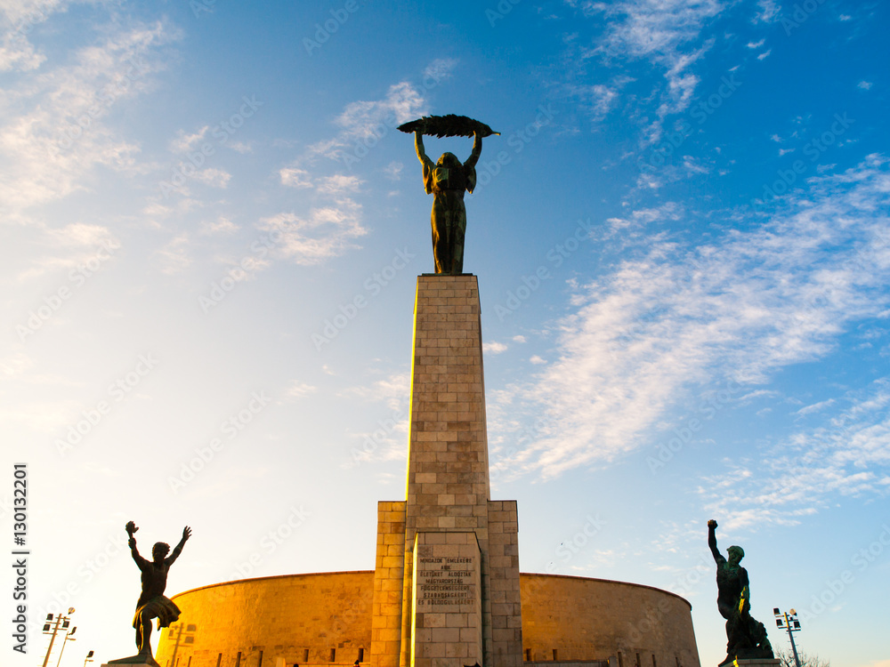 Liberty Statue monument at Citadella on Gellert Hill in Budapest, capital  city of Hungary, Europe. Sunny evening view with blue sky on background.  Stock Photo | Adobe Stock