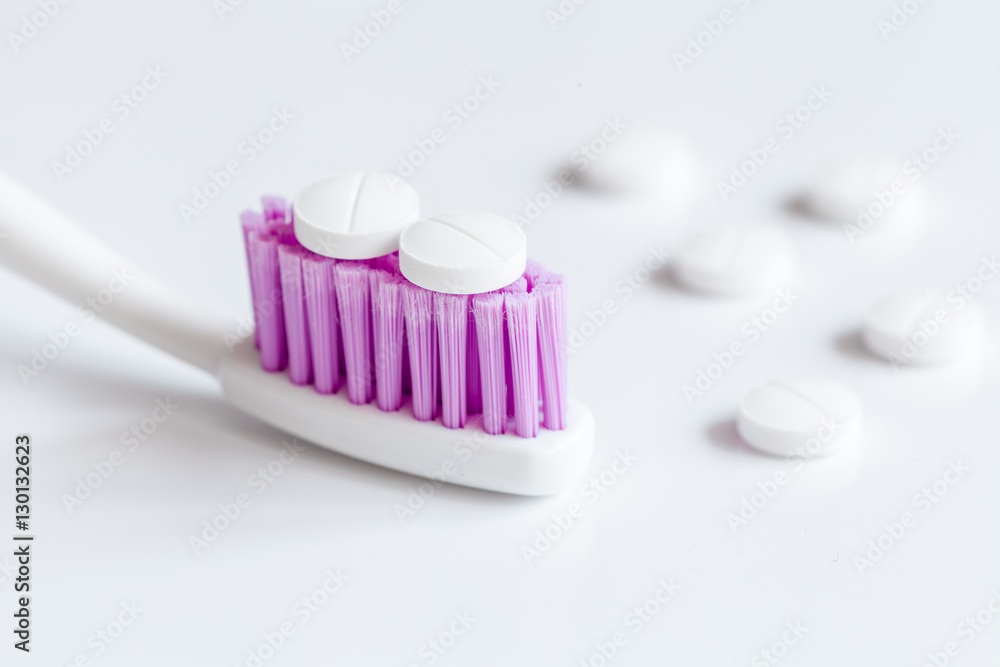 concept toothache with toothbrush and pills at white background concept toothache with toothbrush and pills at white background